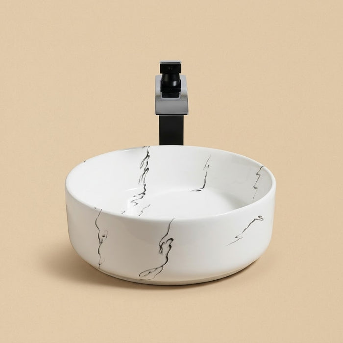 Encre, vasque ronde en céramique blanche veinée d'encre noire avec robinet et bonde